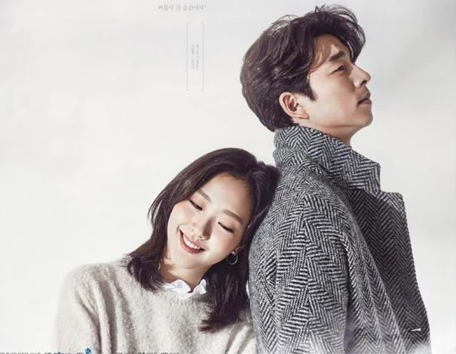 A smiling woman leans against a man's back as he looks upward